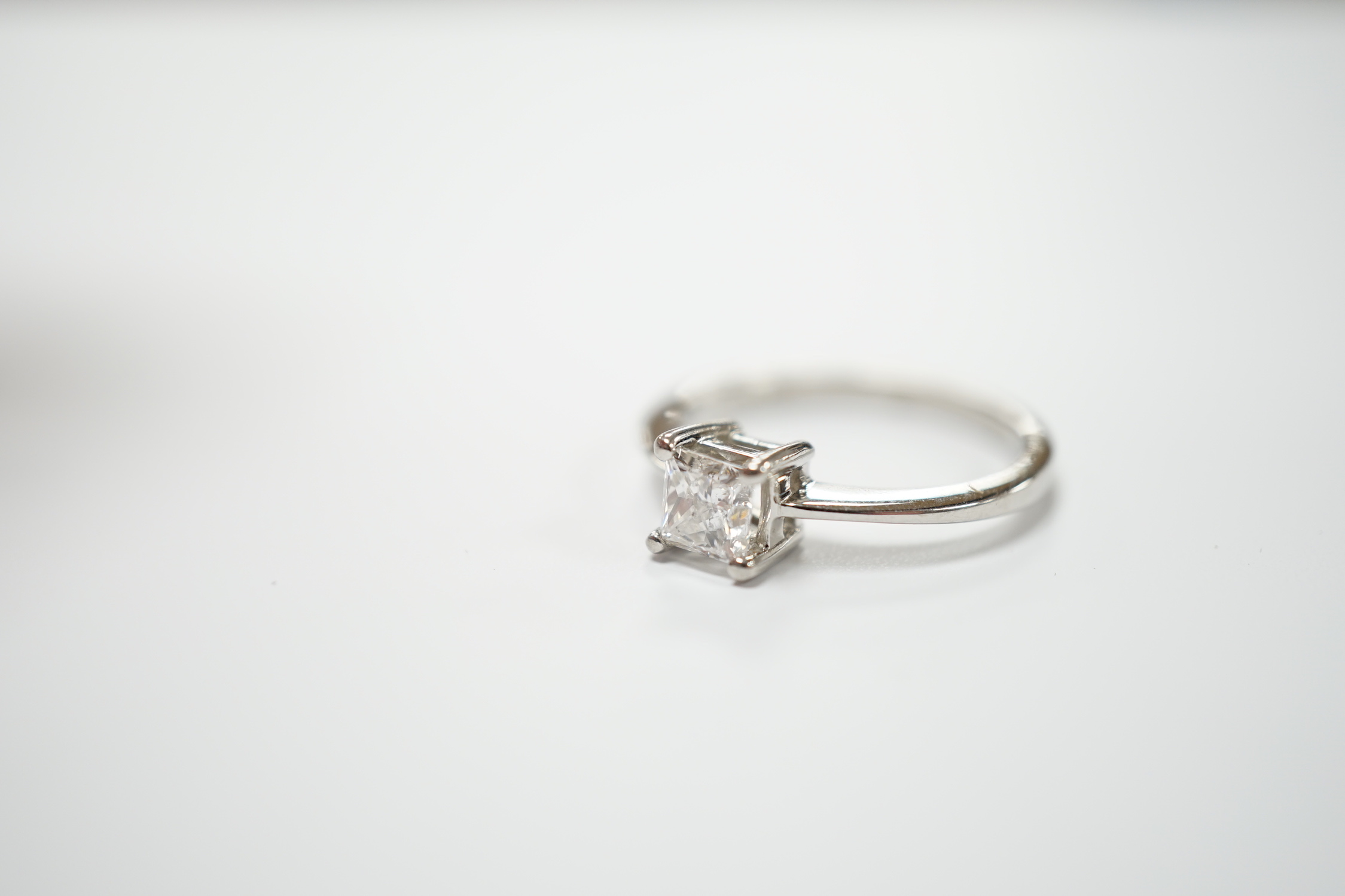 A white metal and princess cut solitaire diamond set ring, the stone weighing 0.50ct, size K, gross weight 3.4 grams.